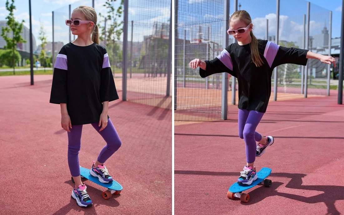 Девочка на скейте на поле.